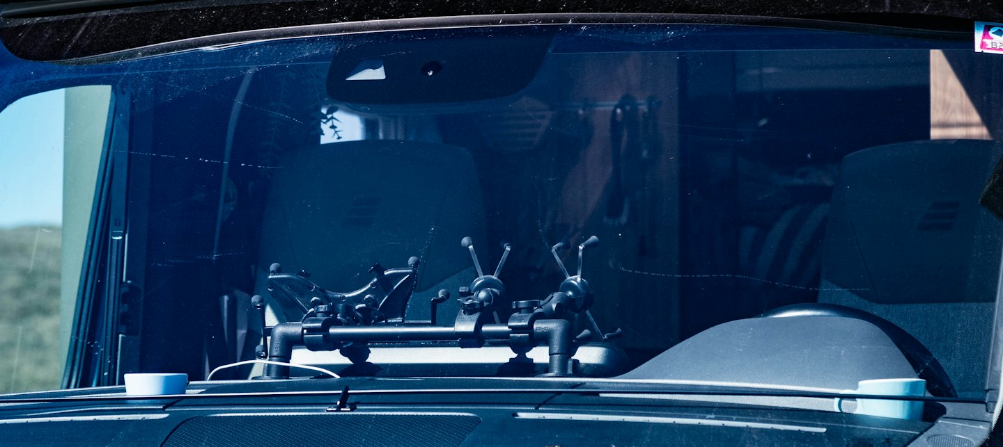 Professional camera rig mounted on a vehicle dashboard.