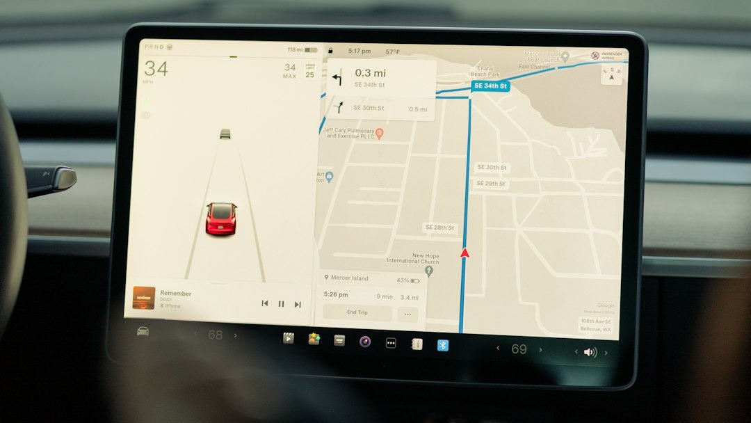 Modern car dashboard screen displaying navigation and media information.